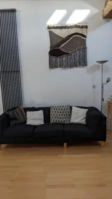 a black couch sitting in a living room at Moss Tarn in Ulverston