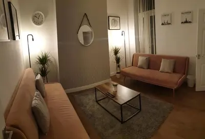 a living room with a couch and a table at 4 Bedrooms, Sleeps 10, Near LFC & EFC in Liverpool