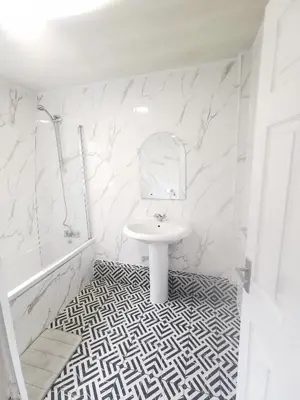 a white bathroom with a sink and a mirror at 4 Bedrooms, Sleeps 10, Near LFC & EFC in Liverpool