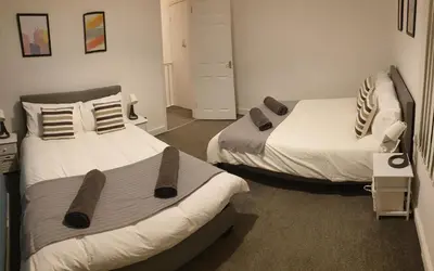 two beds in a room with two beds sidx sidx at 4 Bedrooms, Sleeps 10, Near LFC & EFC in Liverpool