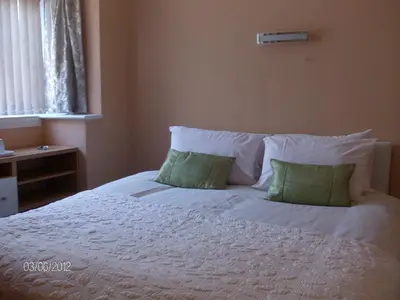 a white bed with two pillows on top of it at Aparthotel Blackpool in Blackpool