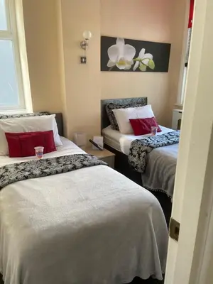 a hotel room with two beds with red pillows at Aparthotel Blackpool in Blackpool