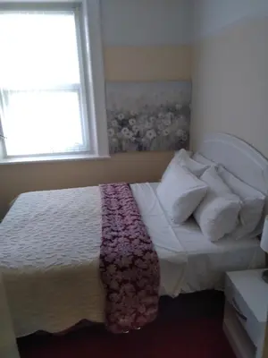 a bedroom with a bed with a blanket on it at Aparthotel Blackpool in Blackpool