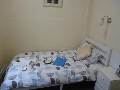 a small bedroom with a bed with a book on it at The Berkswell in Blackpool