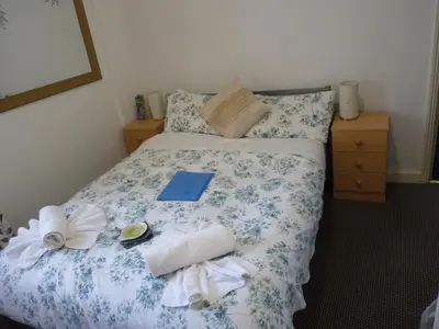 a bed with towels and books on it in a room at The Berkswell in Blackpool
