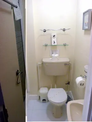a small bathroom with a toilet and a sink at The Berkswell in Blackpool