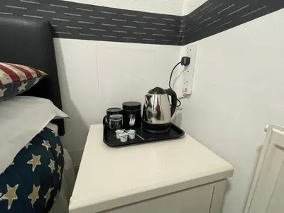 a coffee maker on a table in a bedroom at Manhattan Hotel in Blackpool
