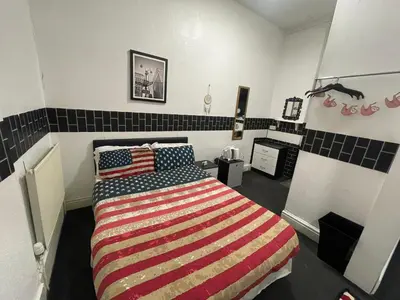 a bedroom with a bed with an american flag bedspread at Manhattan Hotel in Blackpool