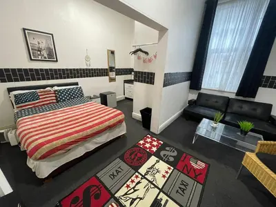 a bedroom with a bed and a couch in a room at Manhattan Hotel in Blackpool