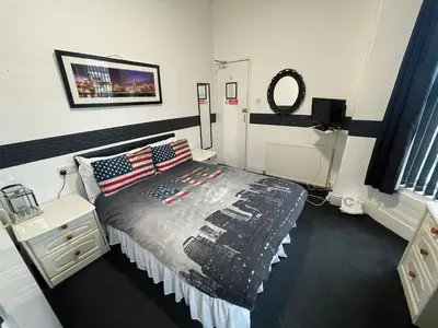 a bedroom with a bed with an american flag blanket at Manhattan Hotel in Blackpool