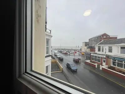 a view of a city street from a window at Manhattan Hotel in Blackpool