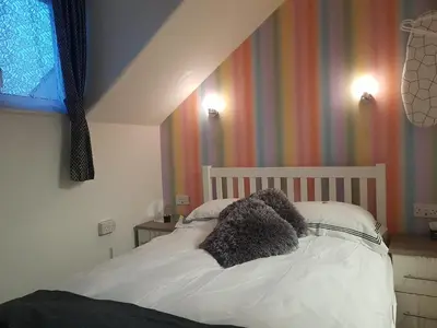 a bed with two teddy bears on top of it at A&P at The Sheron House in Blackpool