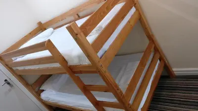 a wooden bunk bed in a room at OYO Wave Crest Hotel in Blackpool