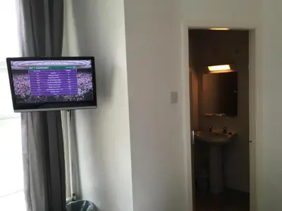 a flat screen tv on the wall of a hotel room at OYO Wave Crest Hotel in Blackpool