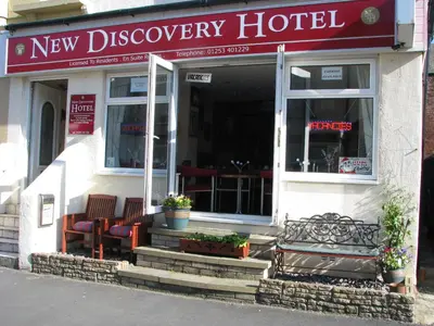 a new discovery hotel with chairs in front of it at MyRoomz New Discovery Hotel in Blackpool