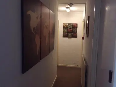 a hallway with a large painting on a wall at MyRoomz New Discovery Hotel in Blackpool