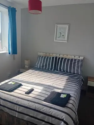 a bed in a bedroom with two towels on it at MyRoomz New Discovery Hotel in Blackpool