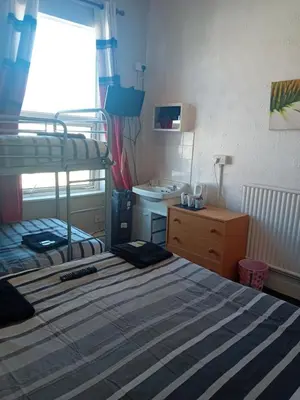 a bedroom with a bunk bed and a sink at MyRoomz New Discovery Hotel in Blackpool