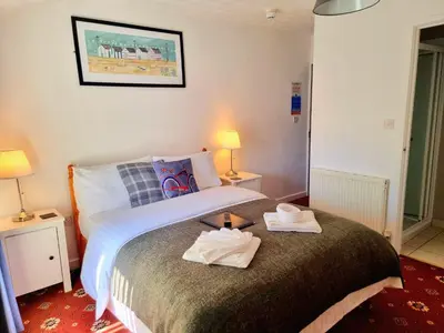 a bedroom with a bed with two towels on it at The Cameo in Blackpool