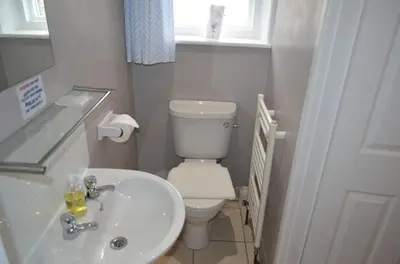 a bathroom with a white toilet and a sink at The Cameo in Blackpool