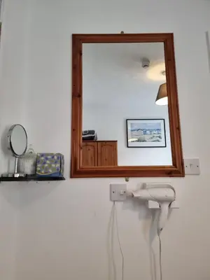 a bathroom with a mirror and a sink at The Cameo in Blackpool