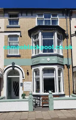 a building with a bench in front of it at The Cameo in Blackpool