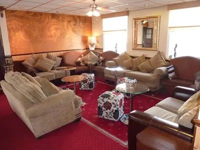 a large living room with couches and tables at The Regal Hotel in Blackpool