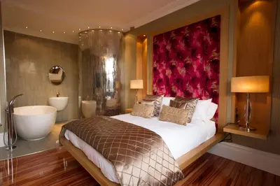 a bedroom with a large bed and a bath tub at Breck Apartments by Central Beach Leisure Ltd in Poulton le Fylde
