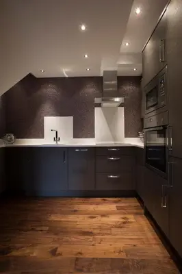 a kitchen with black cabinets and a white counter top at Breck Apartments by Central Beach Leisure Ltd in Poulton le Fylde