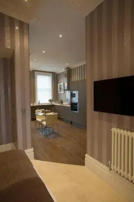 a bedroom with a living room and a kitchen at Breck Apartments by Central Beach Leisure Ltd in Poulton le Fylde