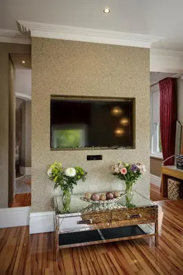 a living room with a flat screen tv on a wall at Breck Apartments by Central Beach Leisure Ltd in Poulton le Fylde