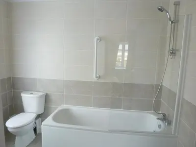 a bathroom with a white tub and a toilet at Orrell Park Hotel in Liverpool