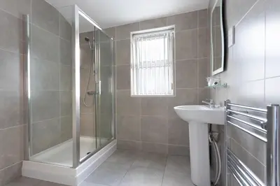 a bathroom with a shower and a sink at Orrell Park Hotel in Liverpool