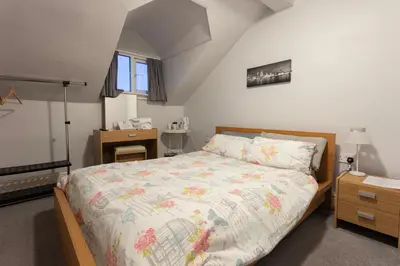 a bedroom with a large bed and a window at Orrell Park Hotel in Liverpool