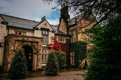 an old house with a christmas tree in front of it at Mitton Hall Hotel in Clitheroe