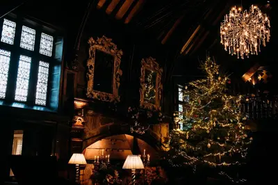 a christmas tree in a room with windows at Mitton Hall Hotel in Clitheroe