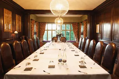 a conference room with a long table and chairs at Mitton Hall Hotel in Clitheroe