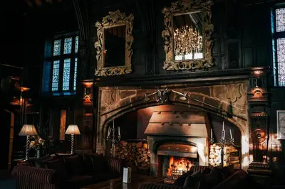 a living room with a fireplace in a building at Mitton Hall Hotel in Clitheroe
