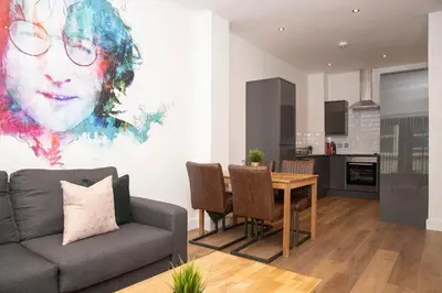 a living room with a couch and a table at SGT Peppers Mathew Street Apartments By Happy Days in Liverpool