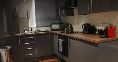 a kitchen with a sink and a counter top at 27 Stanley Street Aparthotel by UStay in Liverpool