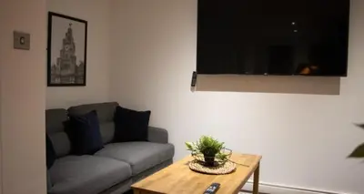 a living room with a couch and a table at 27 Stanley Street Aparthotel by UStay in Liverpool