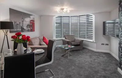 a living room with a couch and chairs and a table at 2 Bedrooms Sleeps 7 Near Top Blackpool Attractions in Blackpool