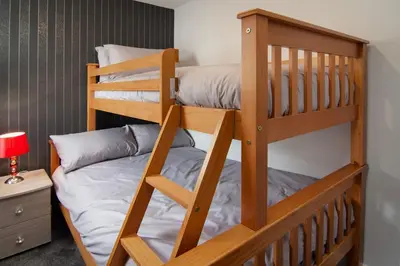 two bunk beds in a room with a bed at 2 Bedrooms Sleeps 7 Near Top Blackpool Attractions in Blackpool