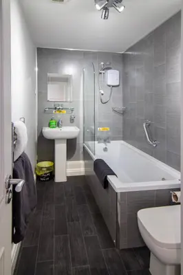 a bathroom with a tub and a sink and a toilet at 2 Bedrooms Sleeps 7 Near Top Blackpool Attractions in Blackpool