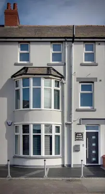 a white house with a lot of windows at 2 Bedrooms Sleeps 7 Near Top Blackpool Attractions in Blackpool