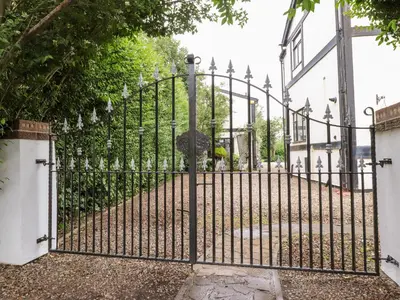 an iron gate with an umbrella on a street at Mayfield Cottage in Blackpool