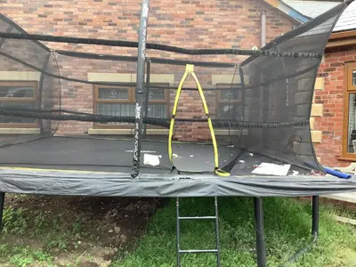 a trampoline with a net on top of it at Grooms cottage in Thornton