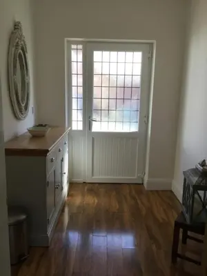 an empty room with a window and a door at Grooms cottage in Thornton