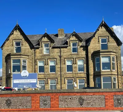 a large brick building with a sign in front of it at Beach Lookout - SEA VIEWS in Lytham St Annes