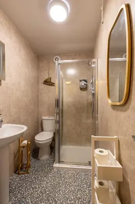a bathroom with a shower and a toilet and a sink at Beach Lookout - SEA VIEWS in Lytham St Annes